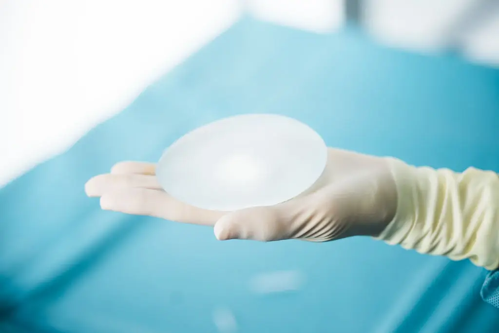 Implant mammaire tenu par une main gantée